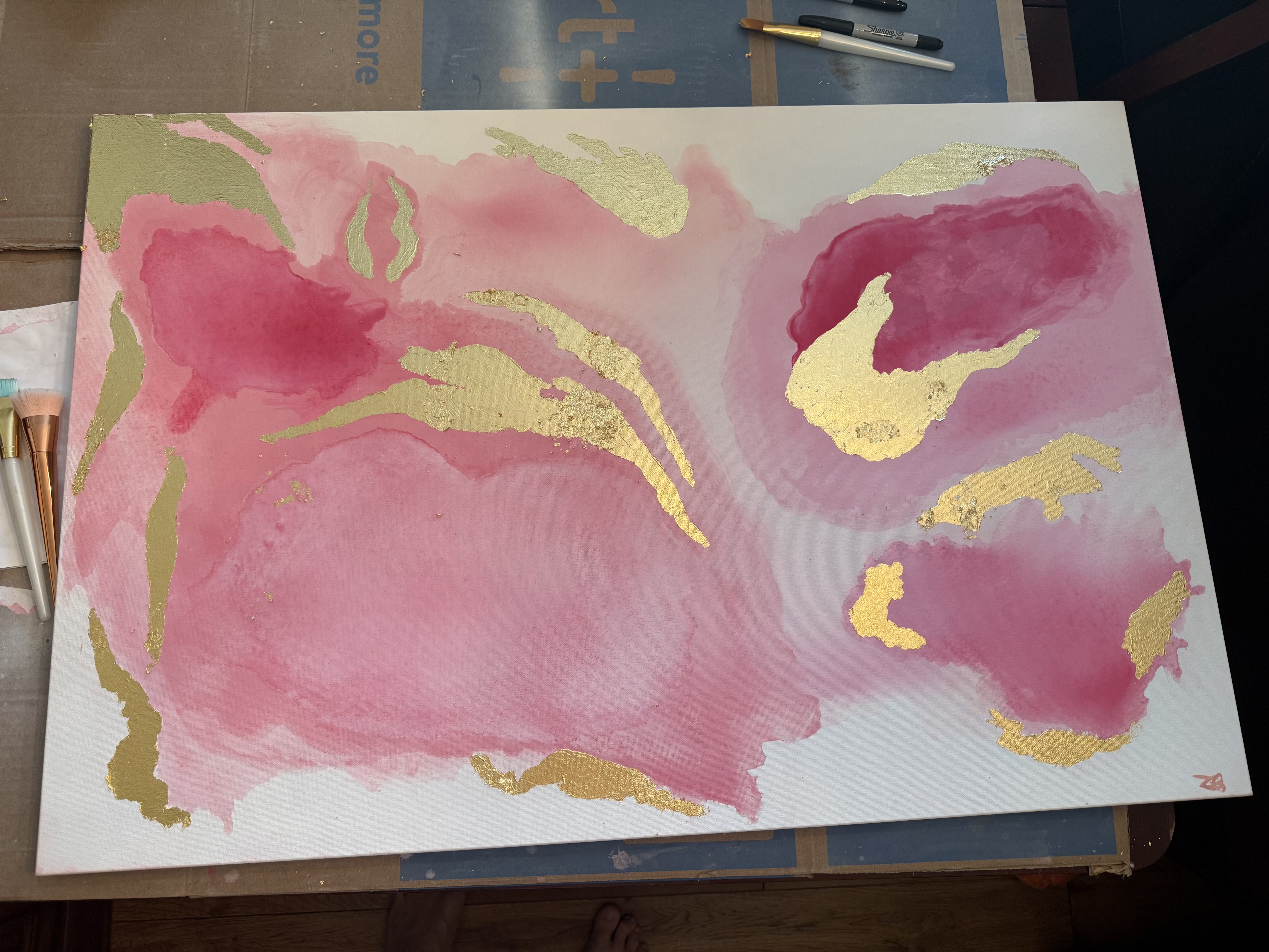 A pink acrylic and gold leaf abstract painting